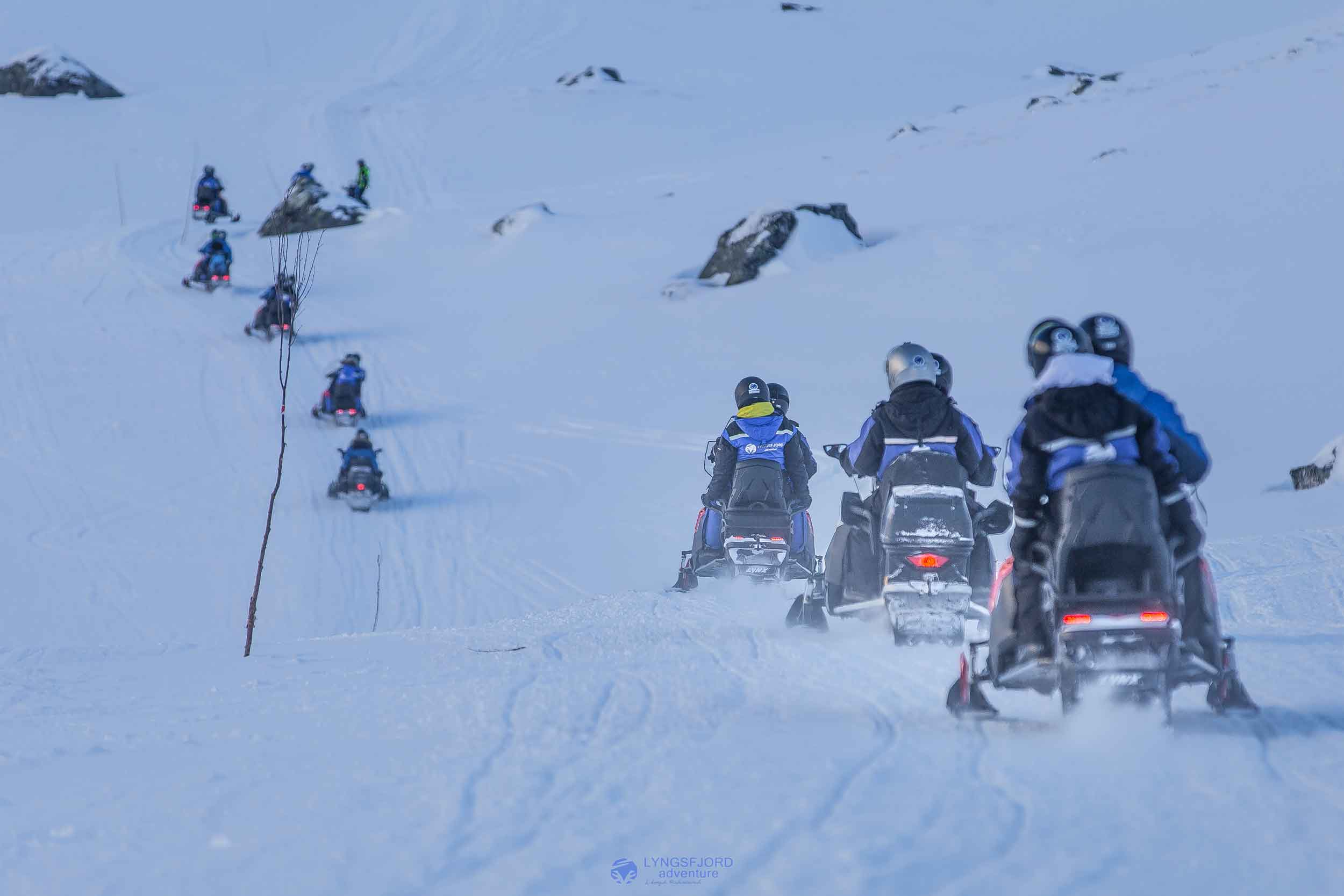 Photo. Group of people on snowmobiles.